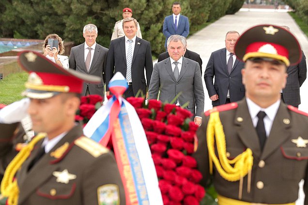 Laying flowers at Monument of Independence and Humanism in Tashkent